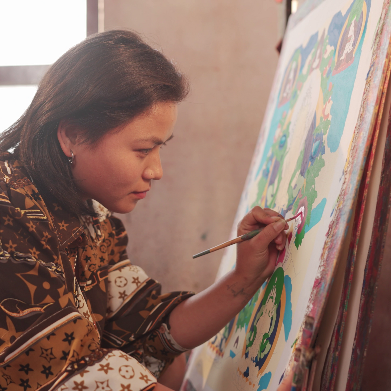 Artist painting thangka